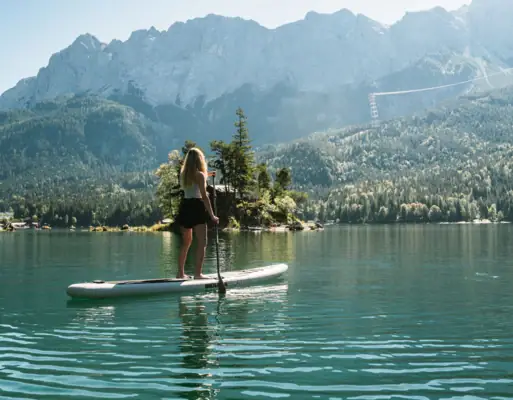 A woman on a paddleboard on a lake.