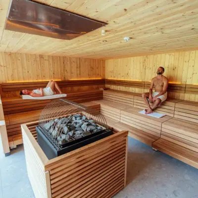 A man and a woman in a sauna.