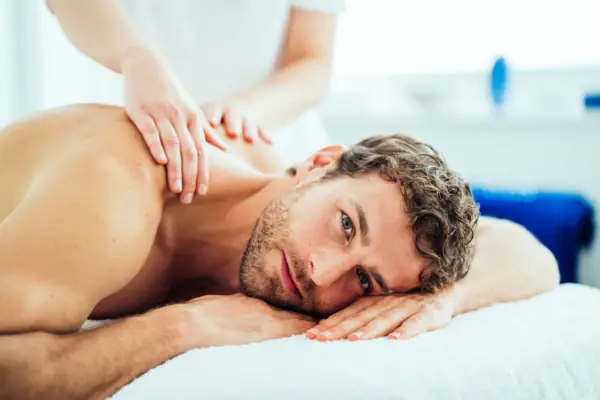 A man is lying on a massage table.