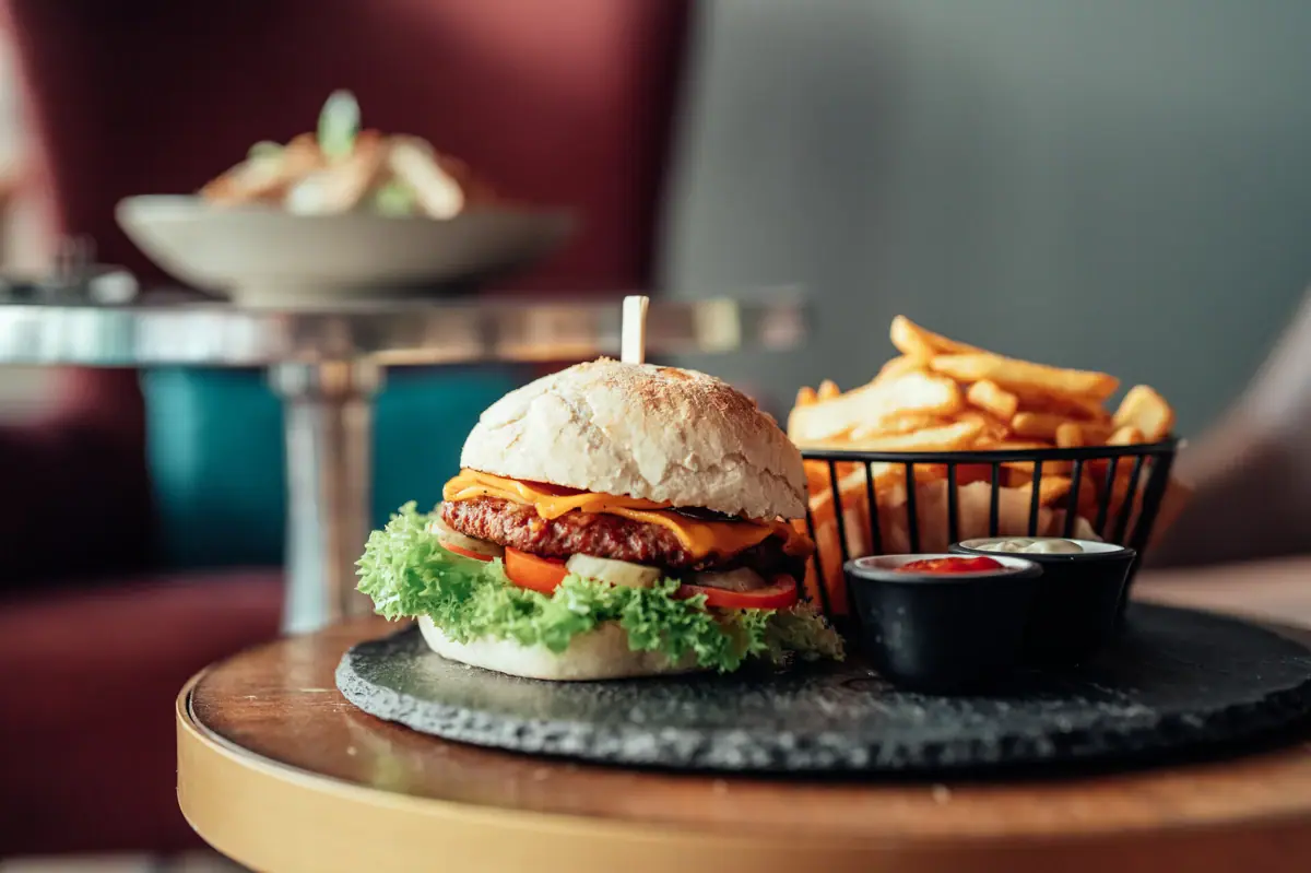 A burger and fries on a table.