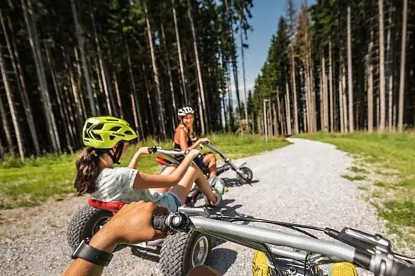 Group of people mountain karting on a gravel road.