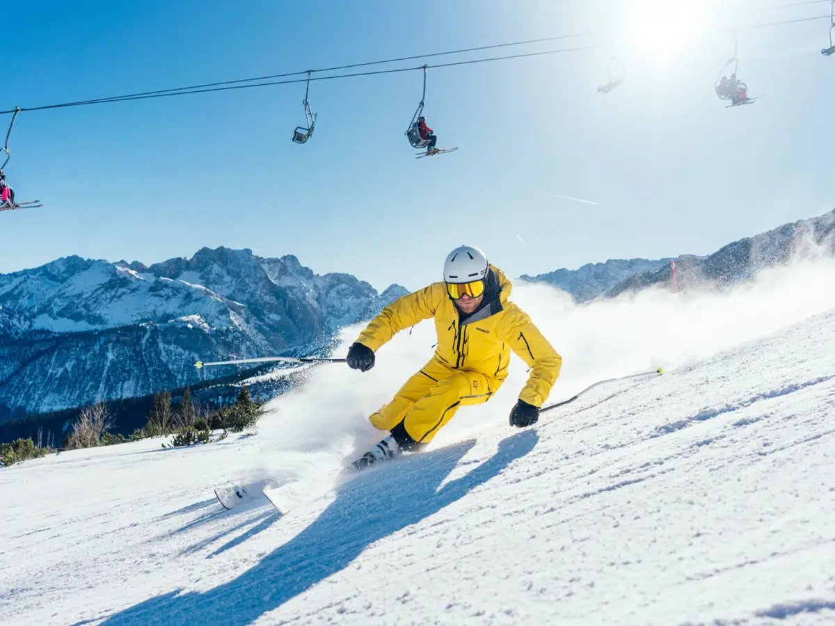 Skier A person skis down a snow-covered mountain.