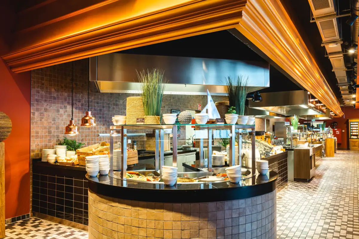 A kitchen with a large counter and large oven.