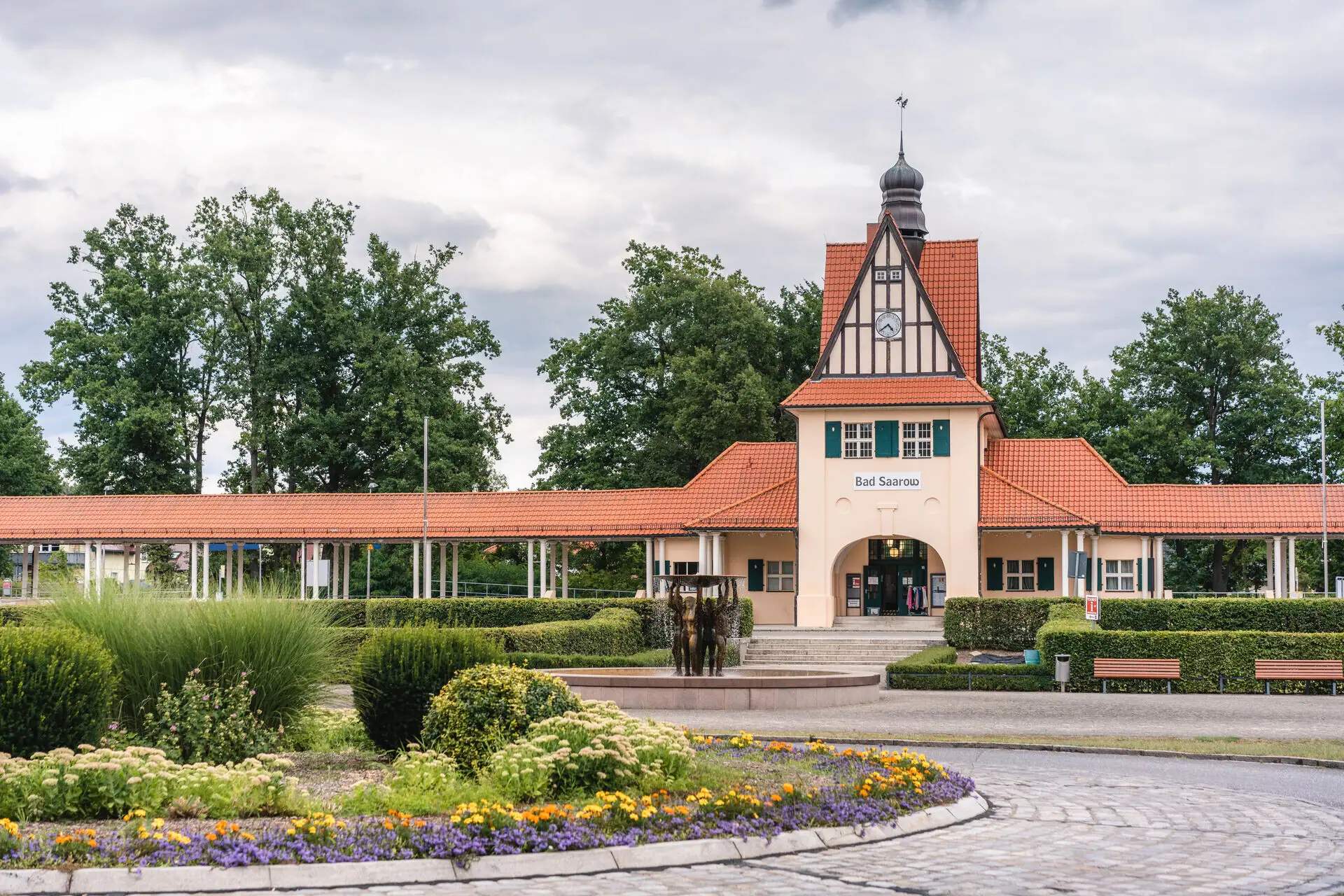 Station building with roundabout in front, beautifully landscaped.
