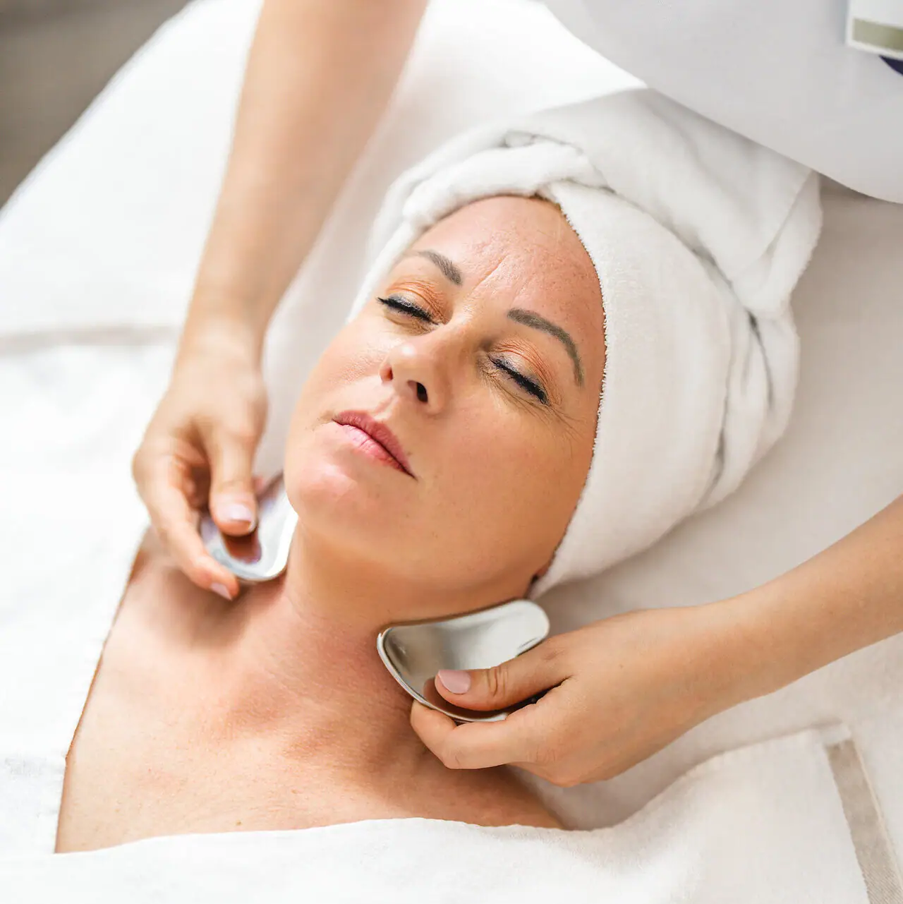 SPA application A woman receives a facial massage.