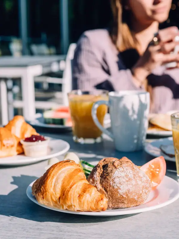 A plate with breakfast on a table.