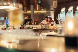 A man and a woman at a bar.