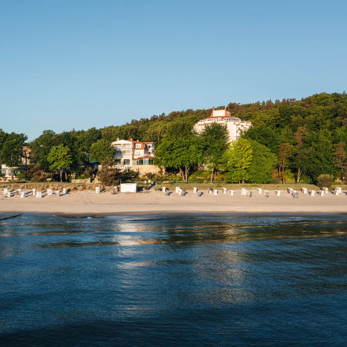 Beach with white buildings and trees