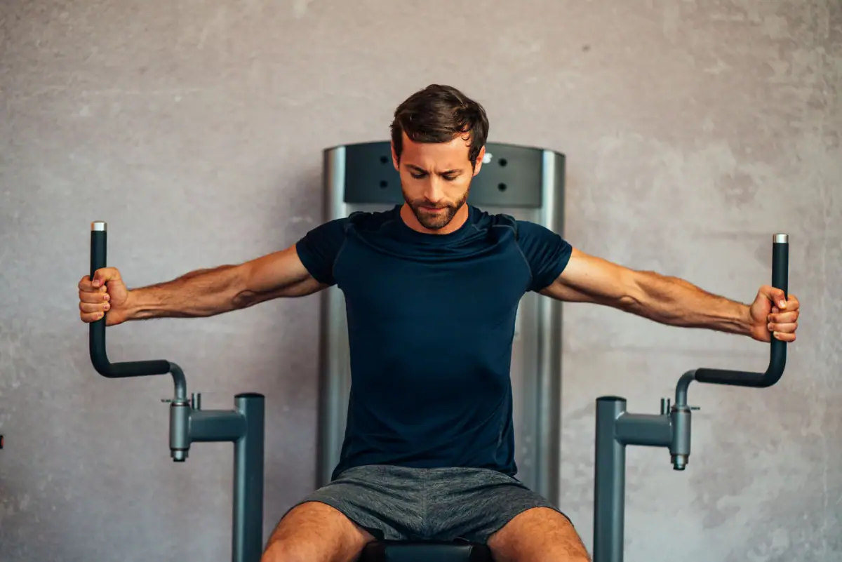 A man trains on a fitness machine.