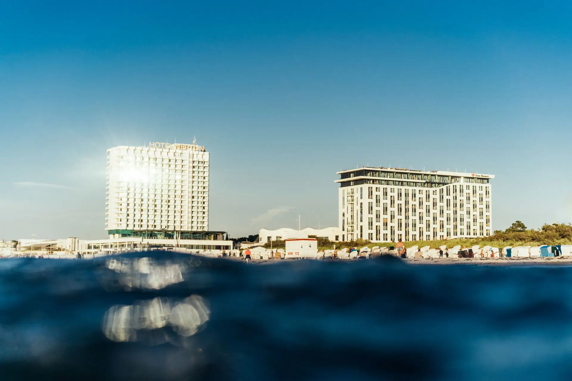 A stretch of water with the Aja Warnemünde in the background.