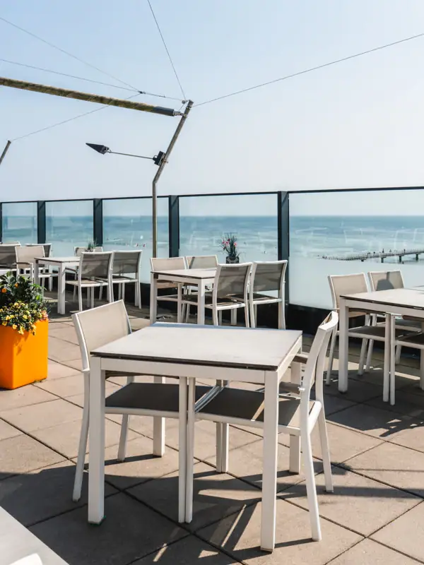 A table and chairs on a terrace.