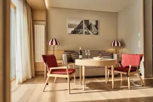 Suite living area A room with a table and chairs.