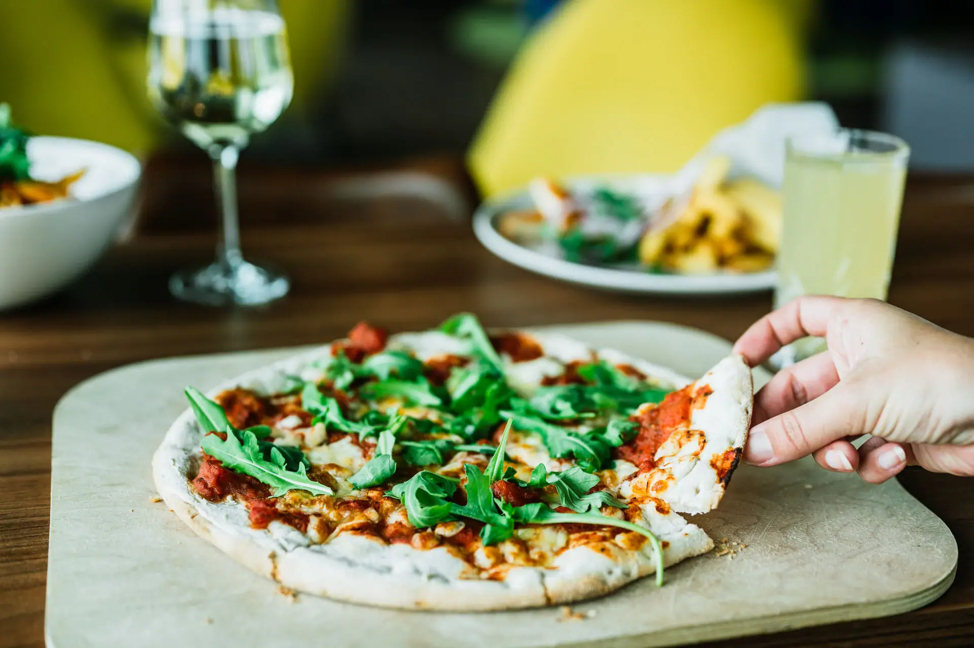 Pizza One hand holds a pizza.