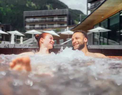 A man and a woman in a hot tub.