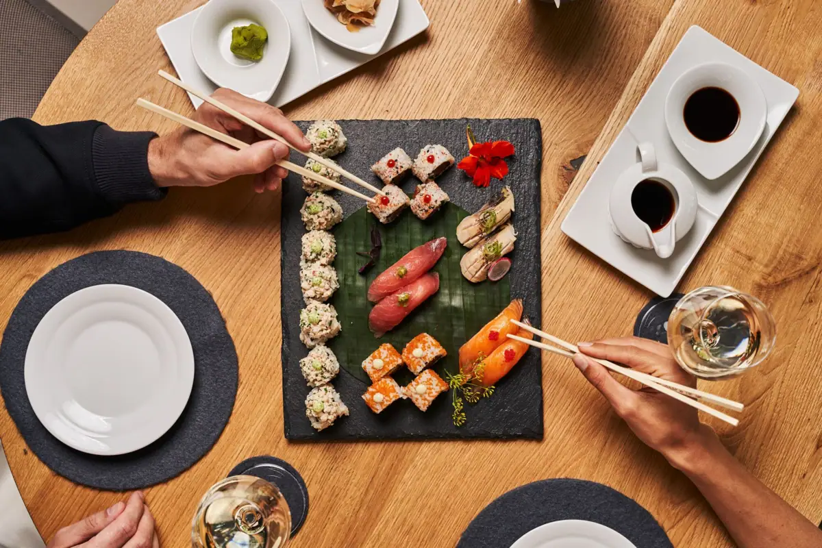 Sushi A group of people eating sushi.