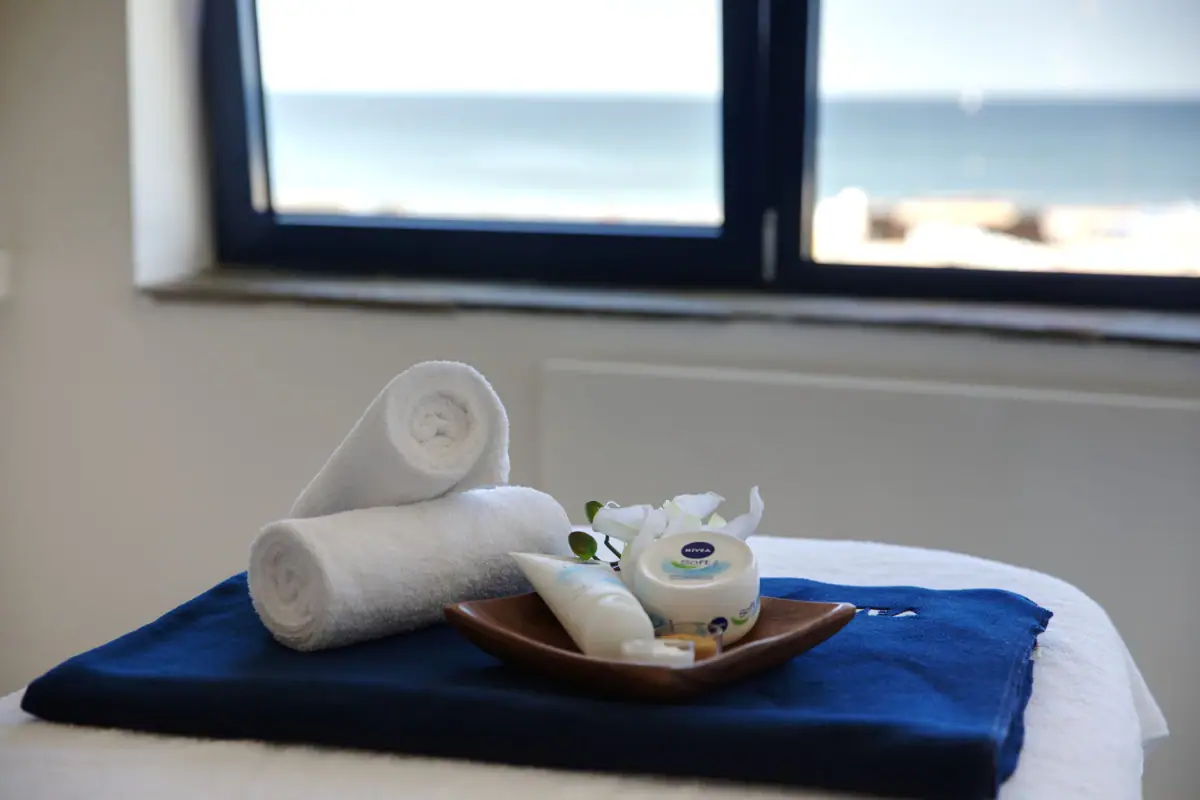 A plate with cream and rolled towels.