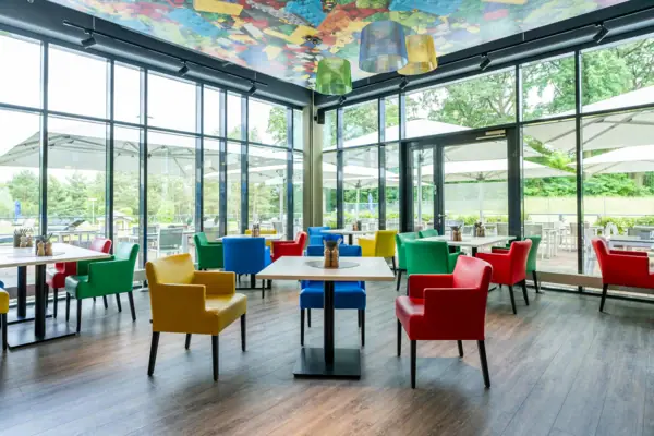 Colourful chairs and tables in a room.