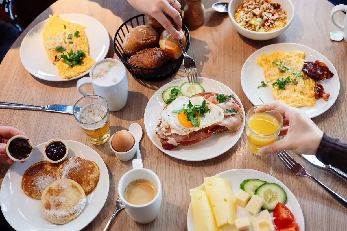 A table laden with food, featuring a variety of dishes and place settings.
