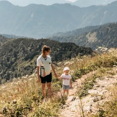 A woman and a child hiking in the mountains.