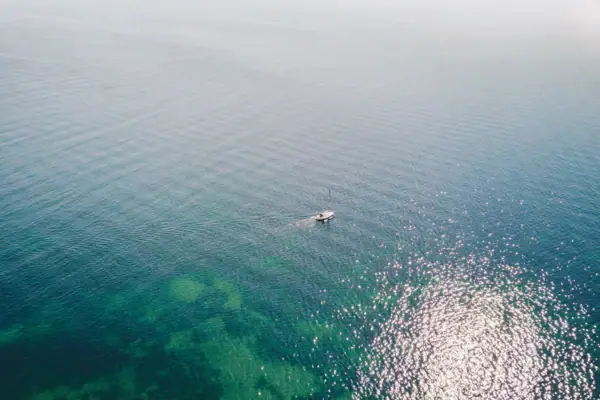 A boat on the water in fog.