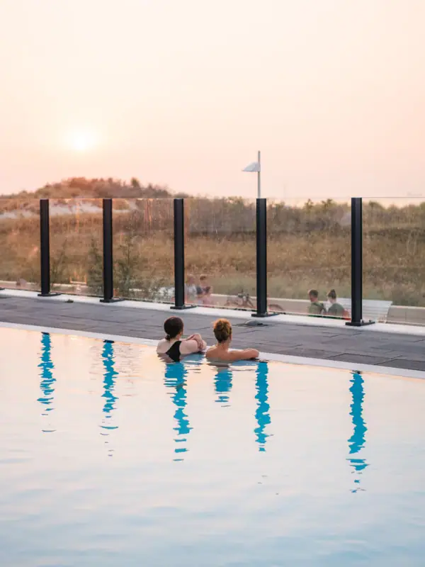 Outdoor pool at the aja Warnemünde Two people swimming in an outdoor pool.