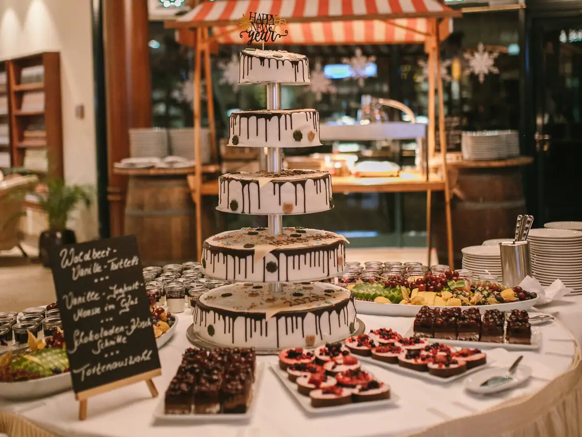 Dessert buffet with a multi-tiered cake and small desserts arranged on a table