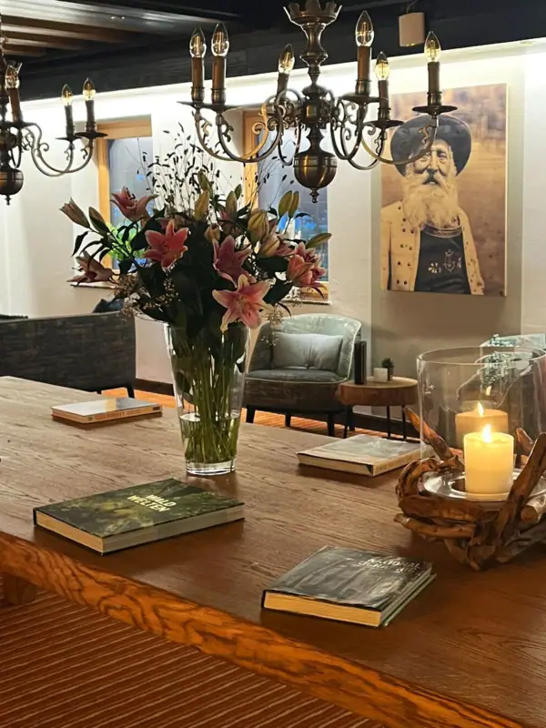 Lounge A table with books and a vase of flowers.