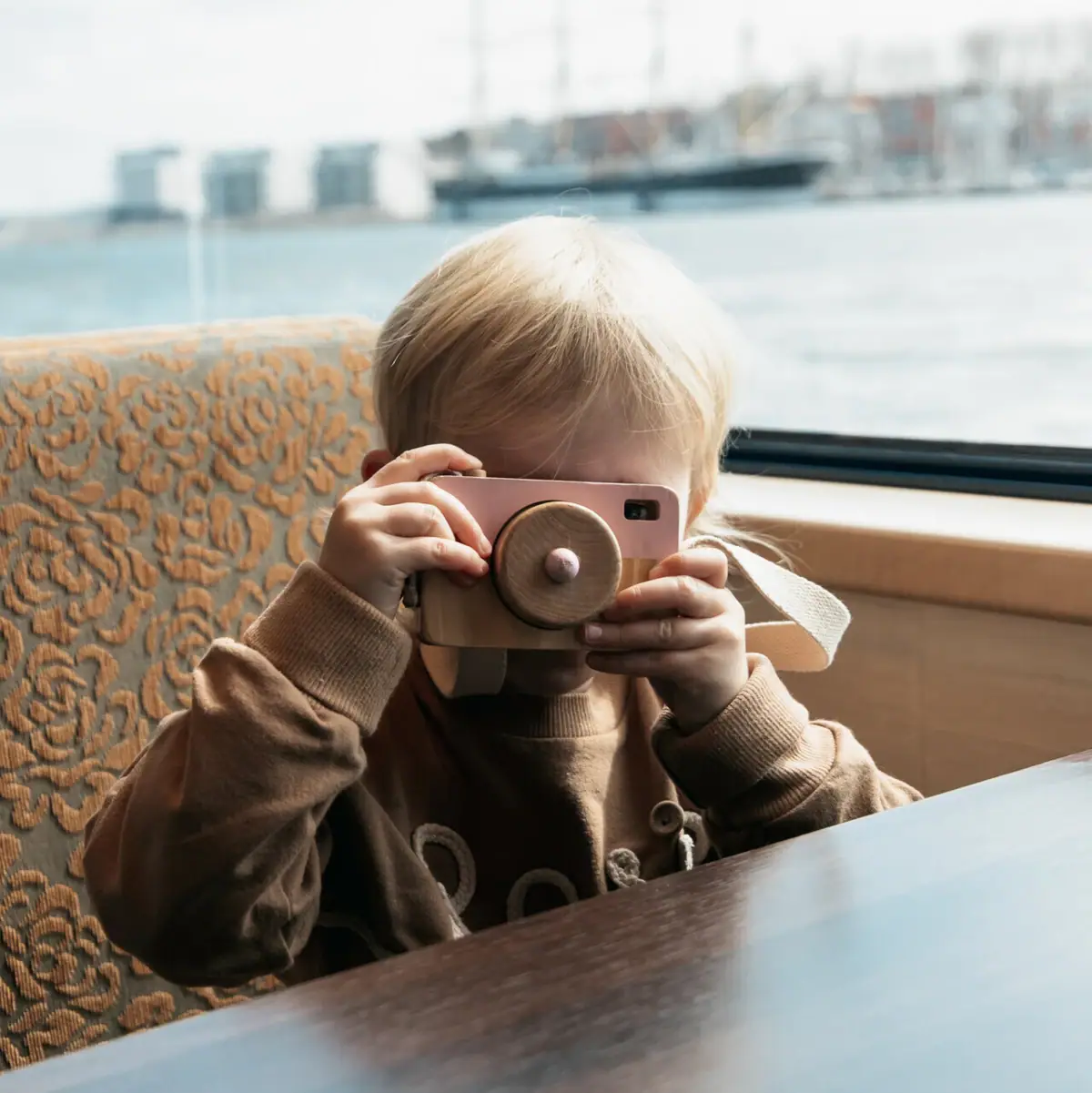 A child holds a camera.