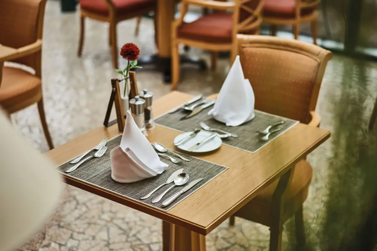 Table in the restaurant A table with napkins and cutlery.