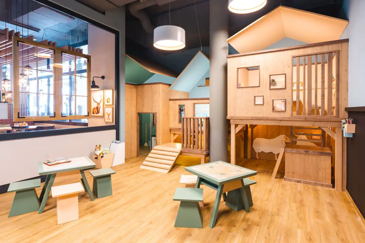 Children's area A room with wooden furniture and a playhouse.