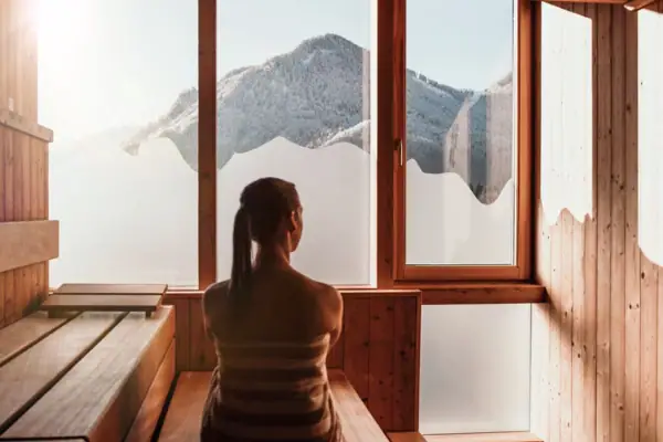 Sauna in winter A woman sits in a sauna.