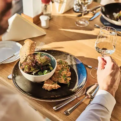 Restaurant Werfenweng A man eats a meal from a plate.