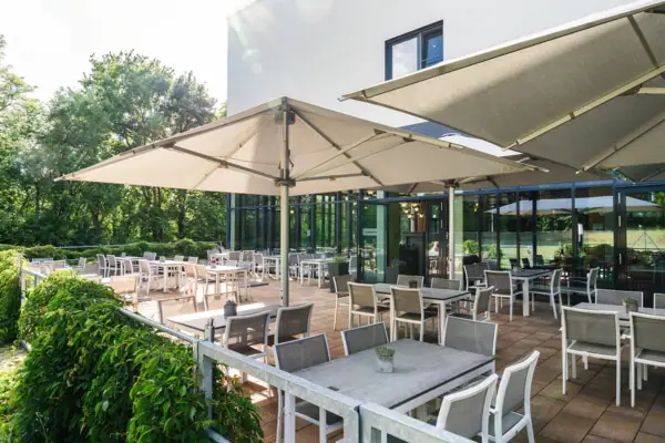 A terrace with outdoor tables and chairs.