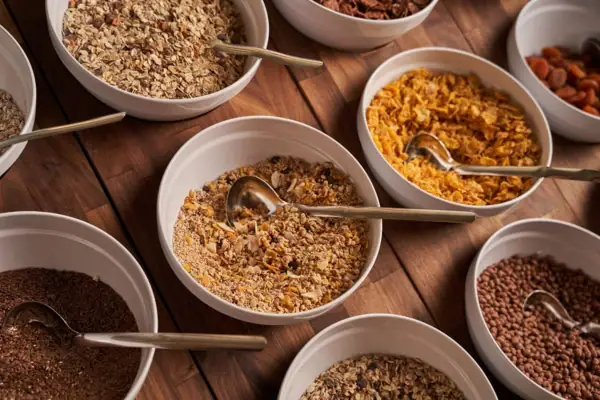 A group of bowls with muesli and cereals.