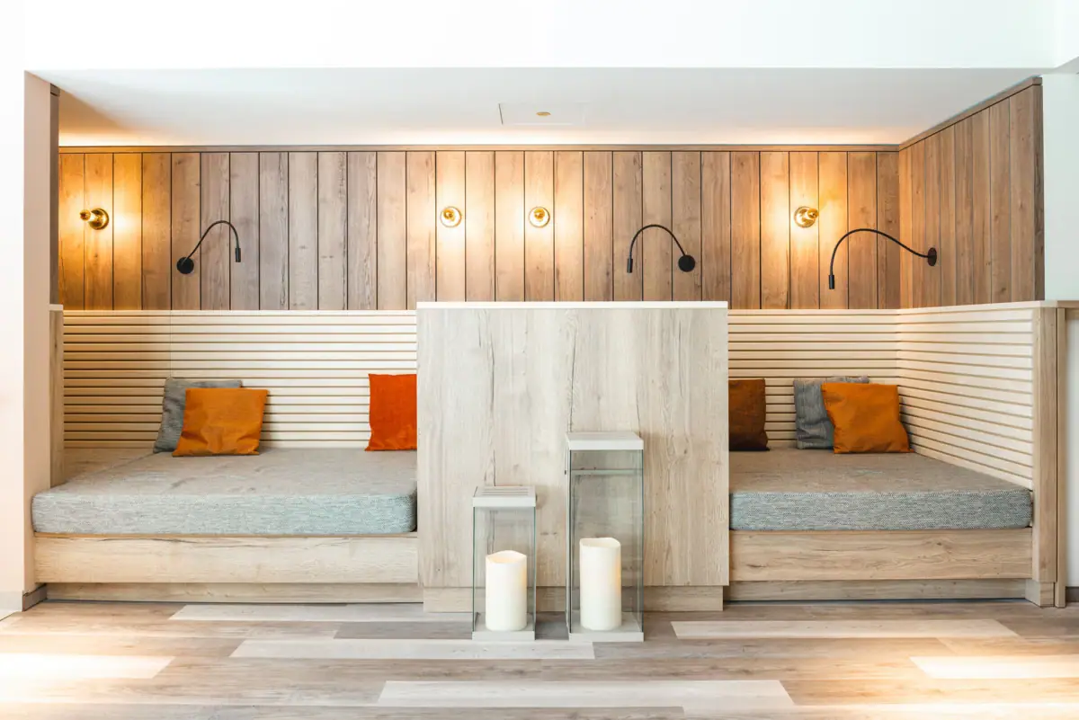 Relaxation room A room with a wooden wall and two lamps.