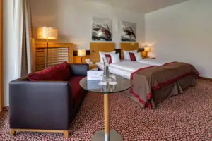 Double room Hotel room with glass table and bed.