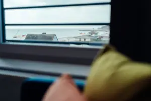 Window with a view of a beach and building