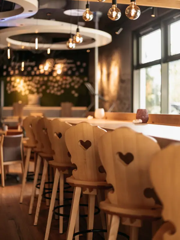 The aja Bar Garmisch-Partenkirchen with chairs and tables.