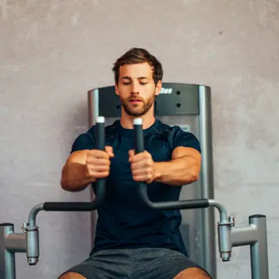 A man trains on a fitness machine.
