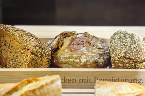 Different types of bread in a wooden box.