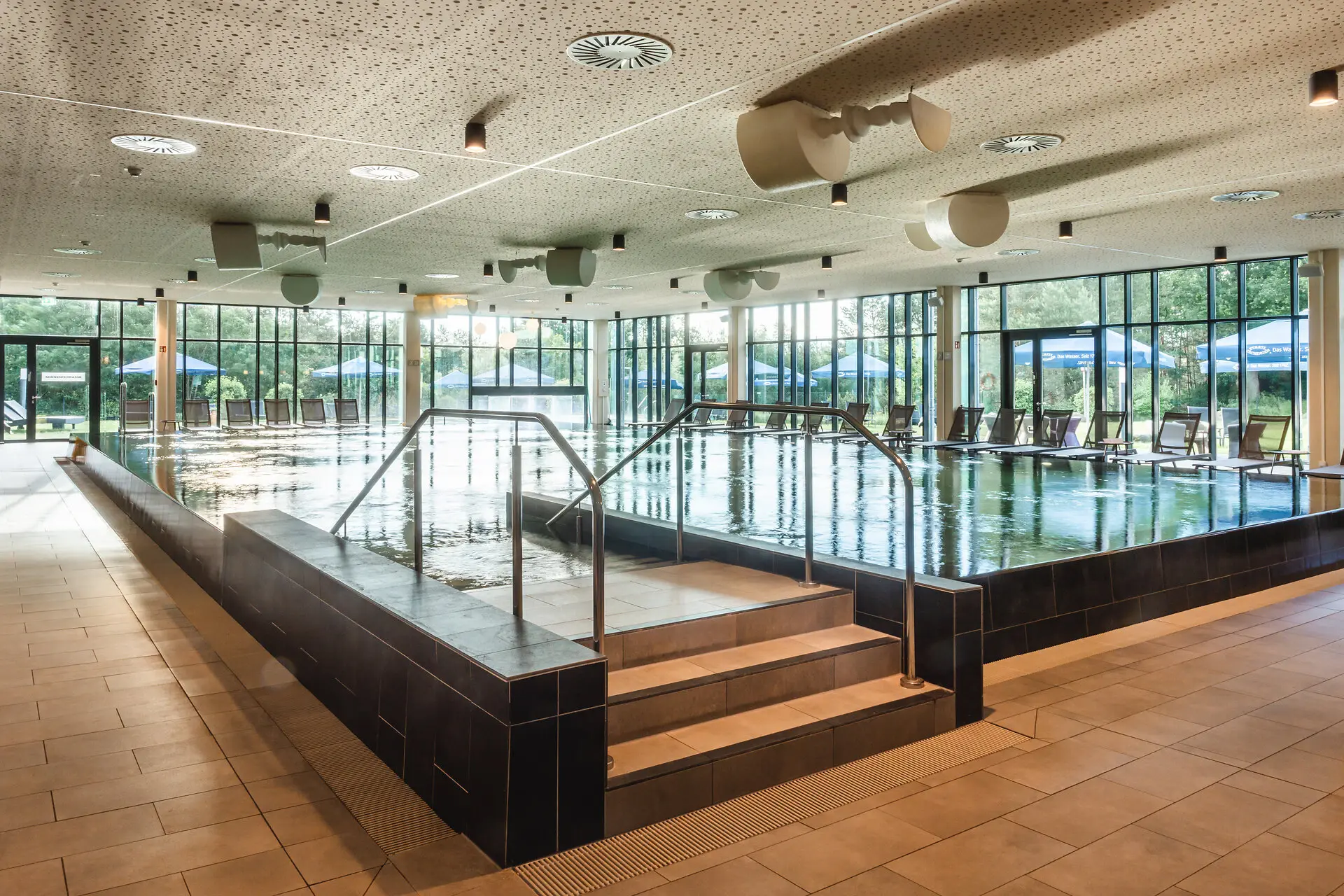 aja SPA in Bad Saarow Large indoor pool with stairs and railings.