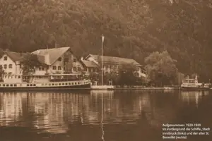 Boat on a lake surrounded by trees and buildings