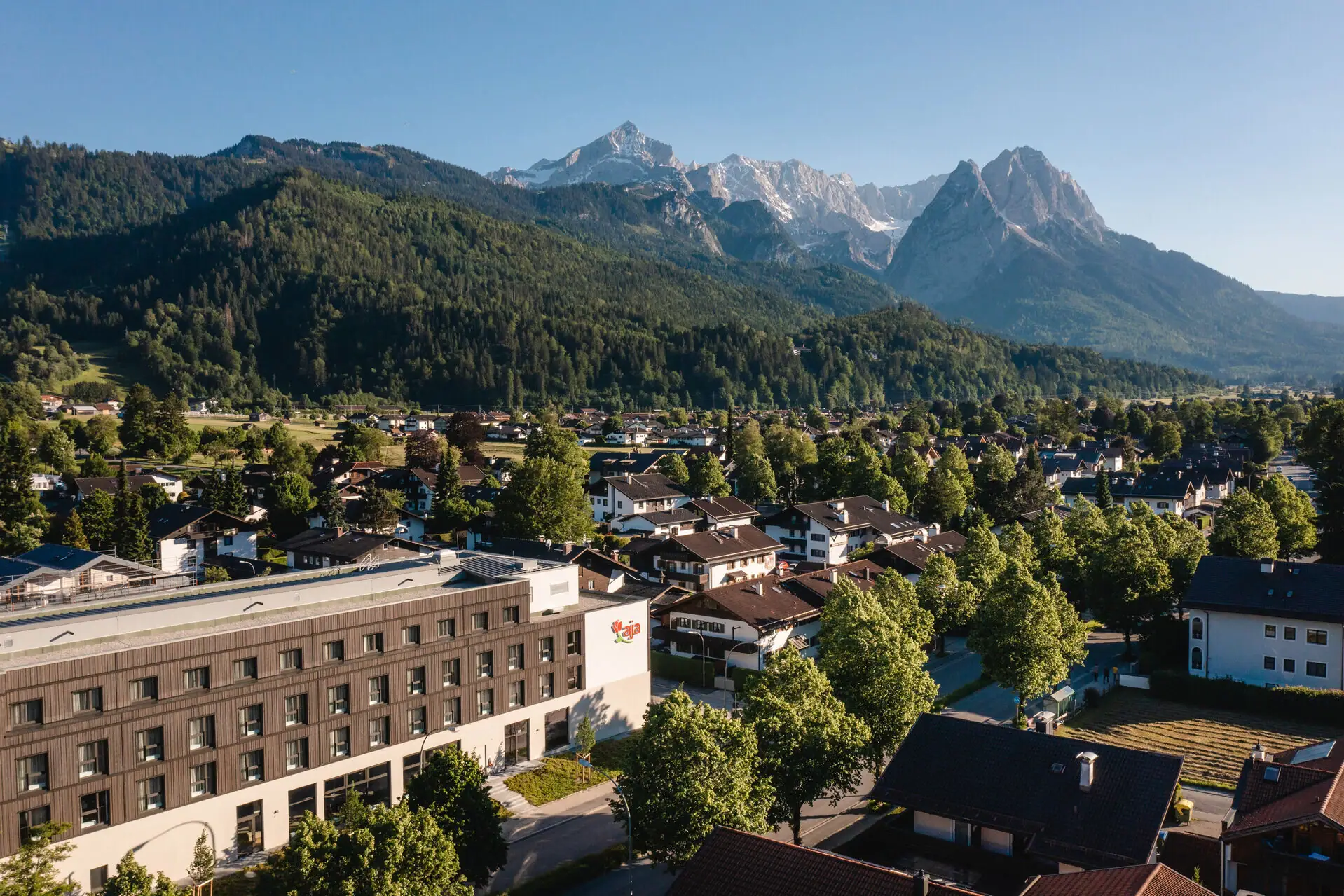 aja Garmisch-Partenkirchen City with trees and mountains in the background.