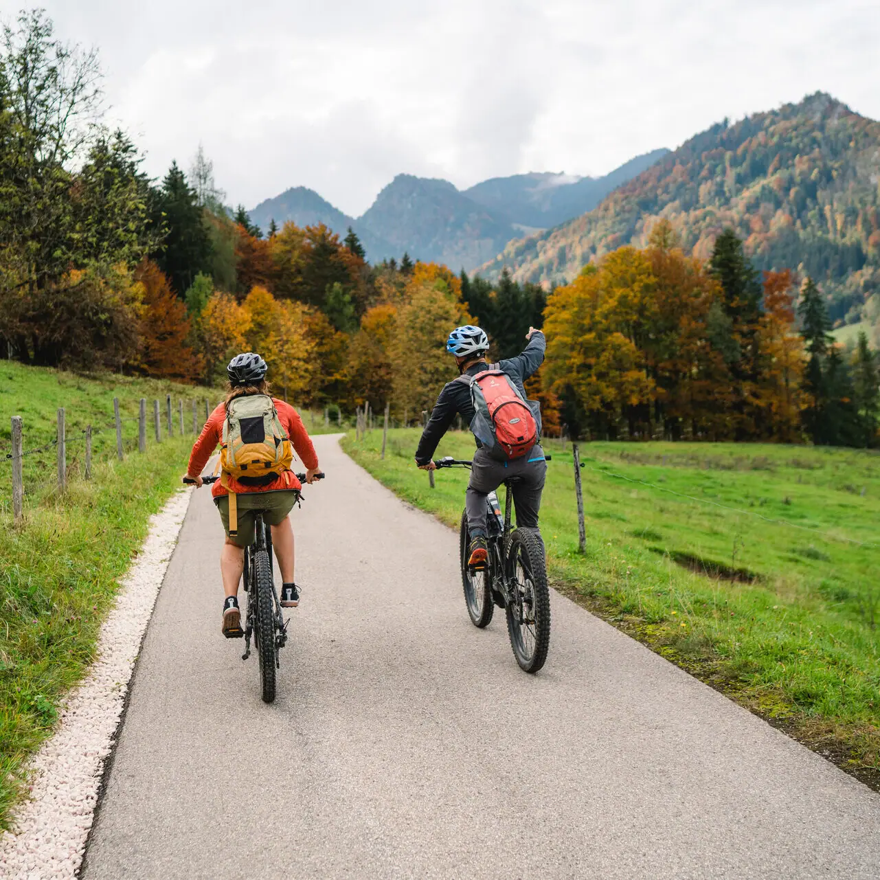 Cycle tour Ruhpolding Two people are cycling on a road in Ruhpolding in Chiemgau.