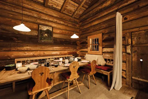 A dining room with a table and chairs.