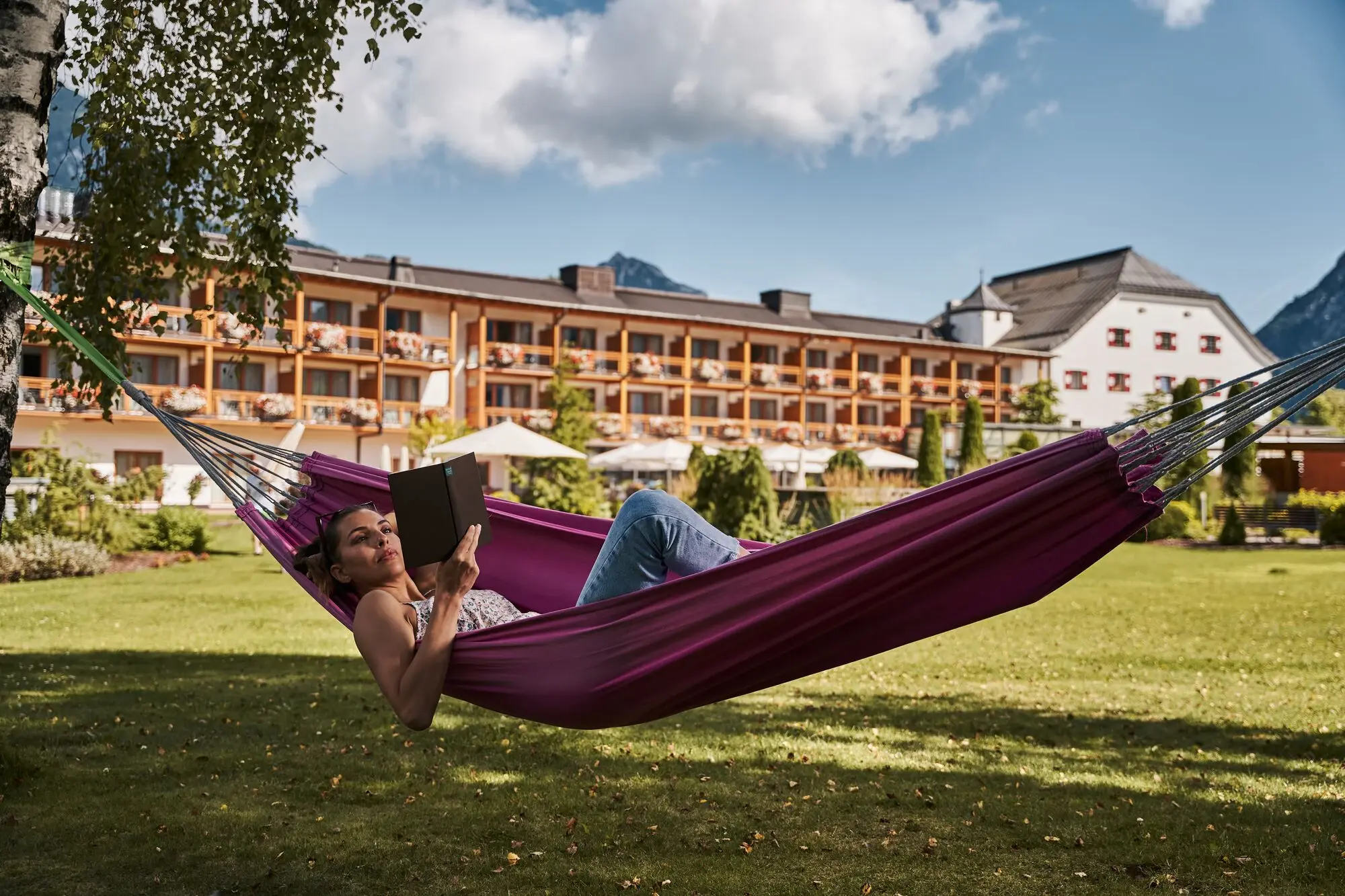 A woman lies in a hammock.