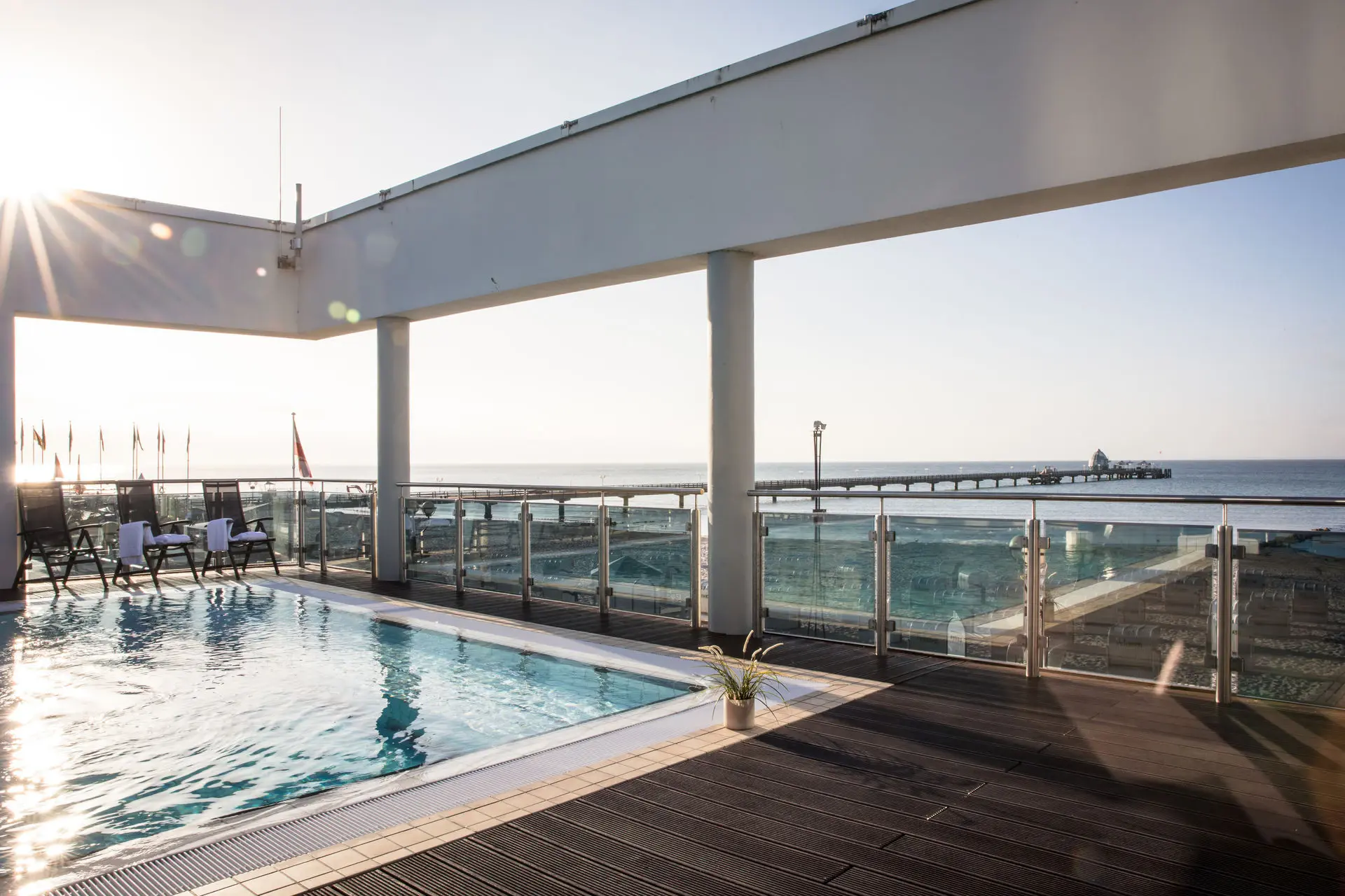 Swimming pool with a terrace and a dock in the background