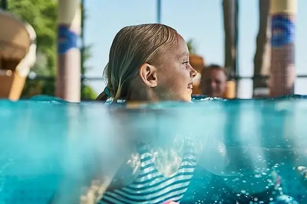 Girl swimming in a pool.