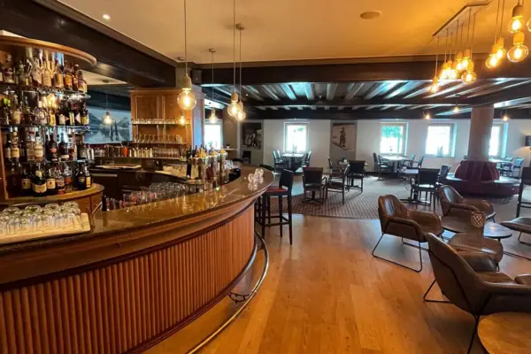 A bar with counter and chairs.