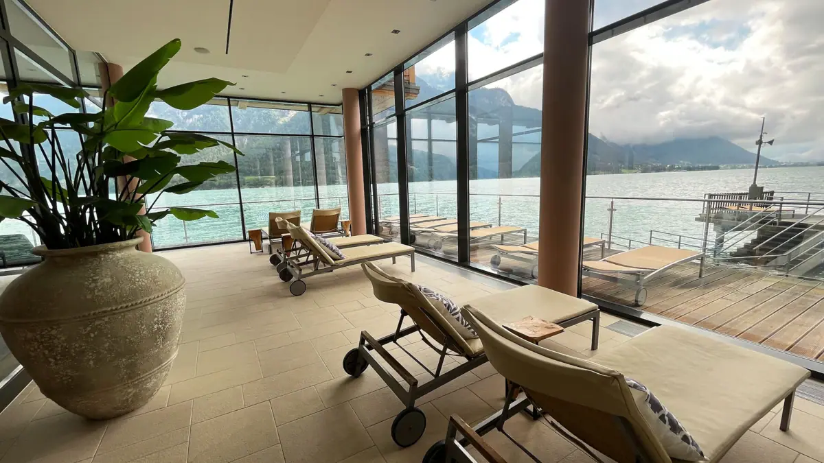 A room with chairs and a view of the water.